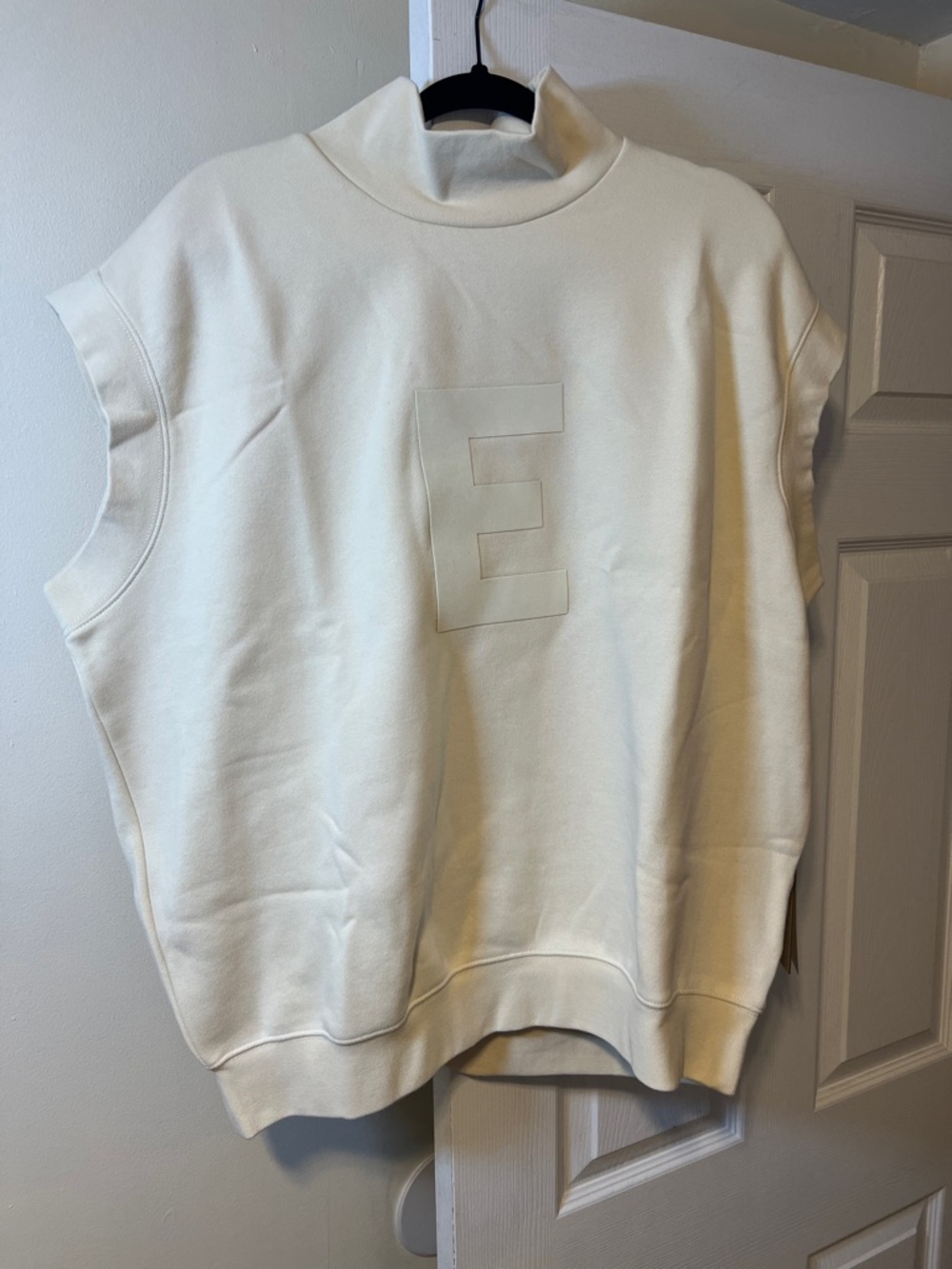 Essentials Oversized Cream Sleeveless Hoodie with Embossed E